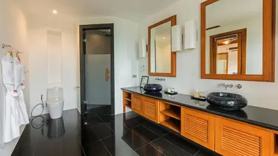 a bathroom with a sink and a mirror at Seaview Villa Yang Som at Surin Beach in Thalang
