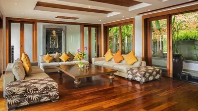 a living room with couches and a coffee table at Seaview Villa Yang Som at Surin Beach in Thalang