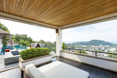a balcony with a view of the city at Seaview Villa Yang Som at Surin Beach in Thalang