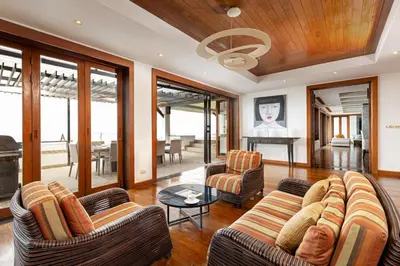 a living room with two couches and a table at Seaview Villa Yang Som at Surin Beach in Thalang