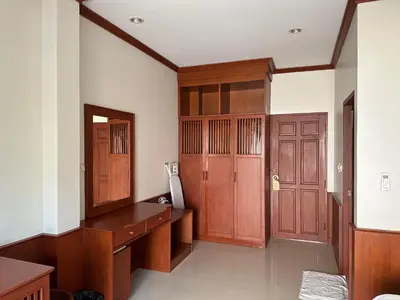 a room with a desk and wooden doors at Sabai Sabai hotel in Kata Beach