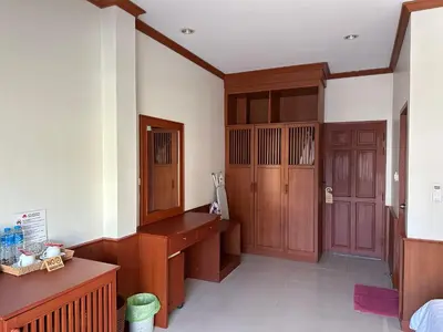 a room with a wooden desk and a wooden door at Sabai Sabai hotel in Kata Beach