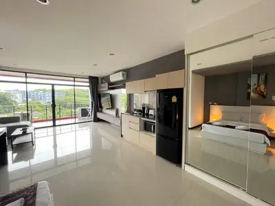 a large room with a kitchen and a living room at Nai Harn spacious studio great amenities in Rawai Beach