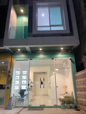 a store front with a glass door and a window at Chalong Inn Phuket in Ban Klang