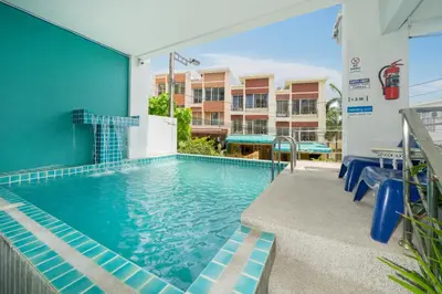 a swimming pool in a building with a building at Kata Sea Boutique in Kata Beach