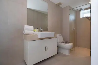 a bathroom with a white sink and a toilet at Kata SeaView 2BR Apartment M12, just 5 min Drive from Kata Beach in Kata Beach