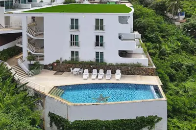 an aerial view of a building with a swimming pool at Kata SeaView 2BR Apartment M12, just 5 min Drive from Kata Beach in Kata Beach