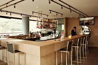 a bar in a restaurant with a person standing at the counter at City Gate Kamala B216 by Phuket Sabay Rent in Phuket Town