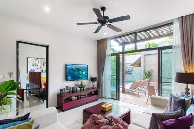 a living room with a couch and a ceiling fan at Stylish 3BR Pool Villa Onyx H4, Gated Residence, Near Rawai & Naiharn Beach in Rawai Beach