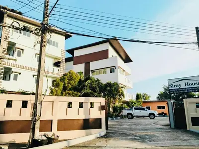 a white building with a fence in front of it at Siray House in Phuket Town