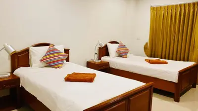 a bedroom with two beds with towels on them at Siray House in Phuket Town