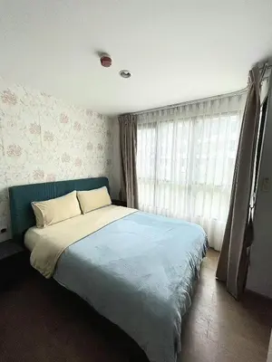 a bedroom with a blue bed with a window at cen 1 bed room 848 in Ban Rangeng