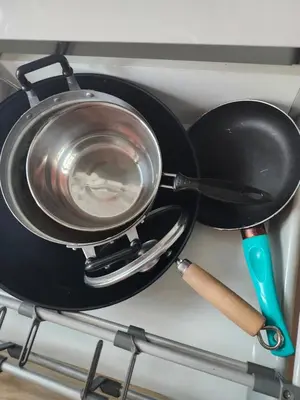 a pan on a stove with a pot on it at cen 1 bed room 848 in Ban Rangeng