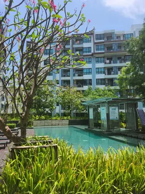 a swimming pool with a building in the background at cen 1 bed room 848 in Ban Rangeng