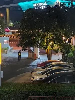 a row of parked cars in a parking lot at night at cen 1 bed room 848 in Ban Rangeng