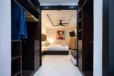 a walk in closet with a bed in a bedroom at Kata Beach Luxury Condo - Spacious - Exquisitely Furnished - 6min walk to beach - 2025 Booking Traveller Award Winner in Kata Beach