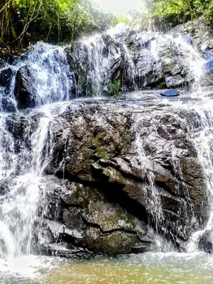 a waterfall on the side of a rock formation at Large Apartment In Lovely Panwa - All Welcome! in Ban Ao Makham