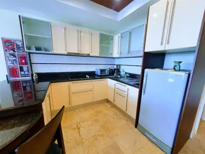 a kitchen with white cabinets and a refrigerator at Large Apartment In Lovely Panwa - All Welcome! in Ban Ao Makham