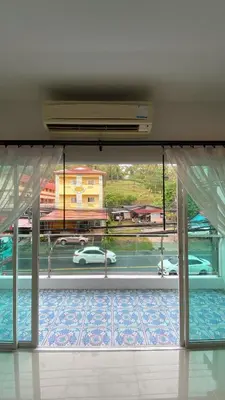 a room with a window with a view of a parking lot at Karon Sea Side in Karon Beach