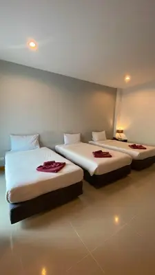 two beds in a room with two beds sidx sidx sidx at Karon Sea Side in Karon Beach