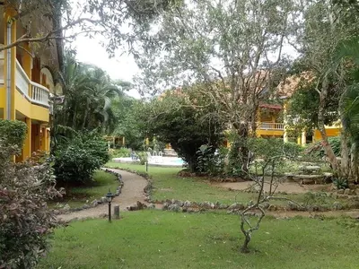 a garden with a path leading to a building at Sabai Residence in Ao Nang Beach