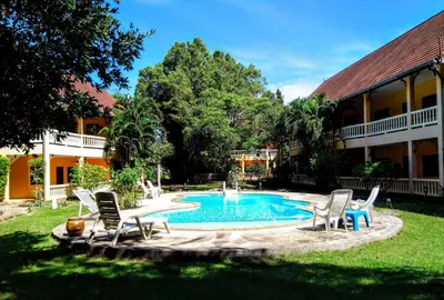a pool in a yard with chairs and a fountain at Sabai Residence in Ao Nang Beach