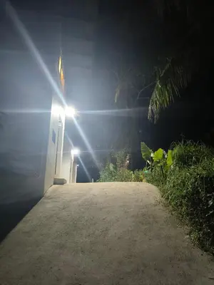 a building with a light at the end of a driveway at Sky Lofts Phuket 2 in Thalang
