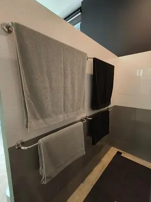 a bathroom with towels hanging on a wall at Sky Lofts Phuket 2 in Thalang