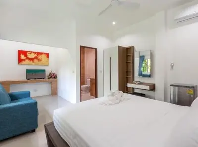 a bedroom with a large bed and a blue couch at Patonghill estate 6 bedroom sea view in Patong Beach