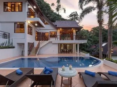 a house with a swimming pool in front of a house at Patonghill estate 6 bedroom sea view in Patong Beach