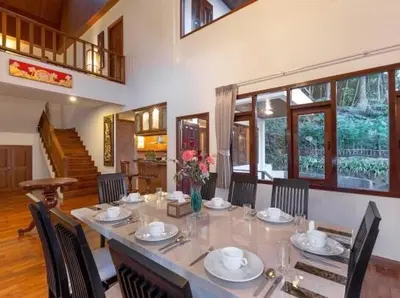 a dining room with a long table with chairs at Patonghill estate 6 bedroom sea view in Patong Beach