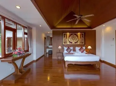 a bedroom with a bed and a ceiling fan at Patonghill estate 6 bedroom sea view in Patong Beach