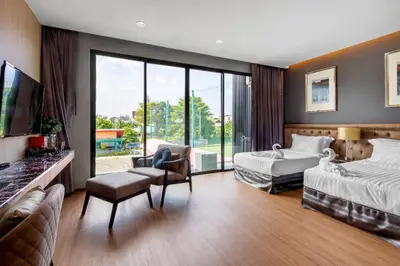 a hotel room with two beds and a flat screen tv at Luxury 2 Bedroom Private Pool Villa in Kamala Walk to Beach Shops and Dining in Kamala Beach