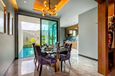 a dining room with a table and chairs at Luxury 2 Bedroom Private Pool Villa in Kamala Walk to Beach Shops and Dining in Kamala Beach