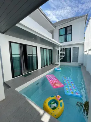a swimming pool with two inflatables in a house at John’s pool villa Rawai in Ban Saiyuan (1)