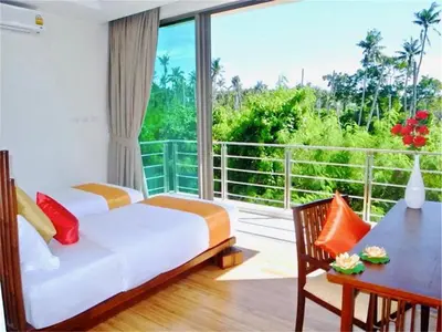 a bedroom with a bed and a table and a balcony at Beautiful Pool Villa near Rawai Beach in Rawai Beach