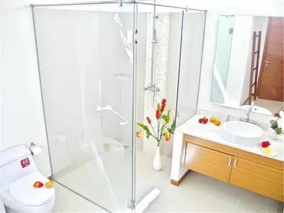 a bathroom with a shower and a toilet and a sink at Beautiful Pool Villa near Rawai Beach in Rawai Beach