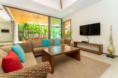 a living room with a couch and a tv at Beautiful Pool Villa near Rawai Beach in Rawai Beach