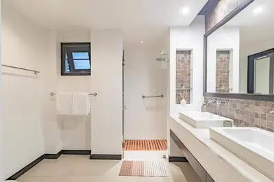 a white bathroom with a sink and a mirror at 3BR Casa Oasis - Beachfront Home in Laguna & Layan Chom Tawan and Maan Tawan Residences in Phuket Town