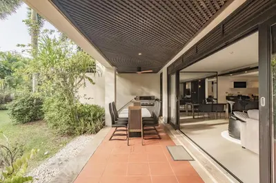 an outdoor patio with a table and chairs at 3BR Casa Oasis - Beachfront Home in Laguna & Layan Chom Tawan and Maan Tawan Residences in Phuket Town