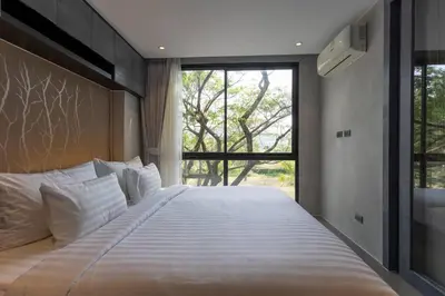a bedroom with a large bed with a large window at Luxury Resort City Gate Kamala C33 in Kamala Beach