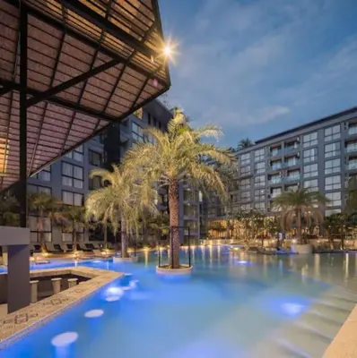 a large pool with palm trees in a building at Luxury Resort City Gate Kamala C33 in Kamala Beach