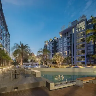 a large building with a pool in front of a building at Luxury Resort City Gate Kamala C33 in Kamala Beach