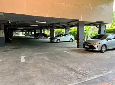 two cars parked in a parking lot at Aristo Resort Surin Beach M06 in Phuket Town