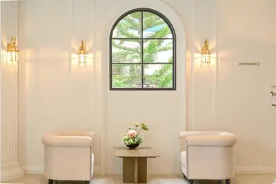 a waiting room with two chairs and a window at Chateau Du Village Patong in Patong Beach