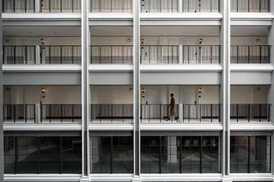 a man standing on the balcony of a building at Chateau Du Village Patong in Patong Beach
