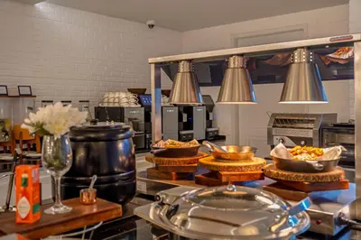 a kitchen with bowls of food on a counter at Chateau Du Village Patong in Patong Beach