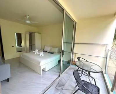 a bedroom with a bed and a table and chairs at Great value! Convenient studio near Kamala beach in Kamala Beach
