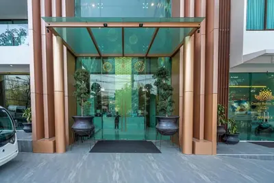 a glass entrance to a building with potted plants at Great value! Convenient studio near Kamala beach in Kamala Beach