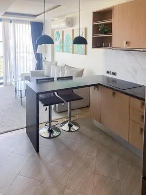 a kitchen with a large black counter top in a room at Appartements avec piscine in Rawai Beach